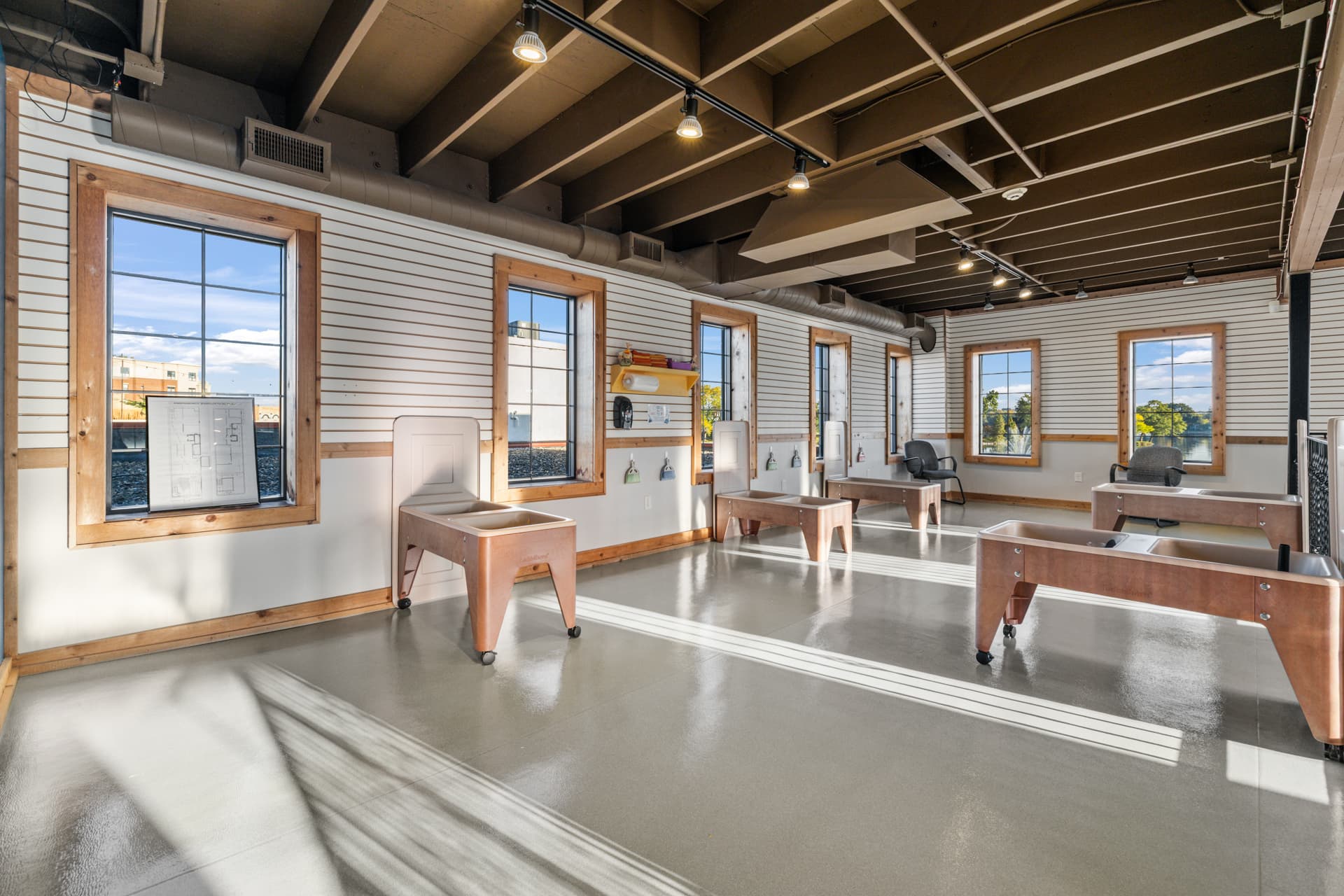 Sunny upstairs sensory room with sand and water tables overlooking the lake at Six Little Ducks