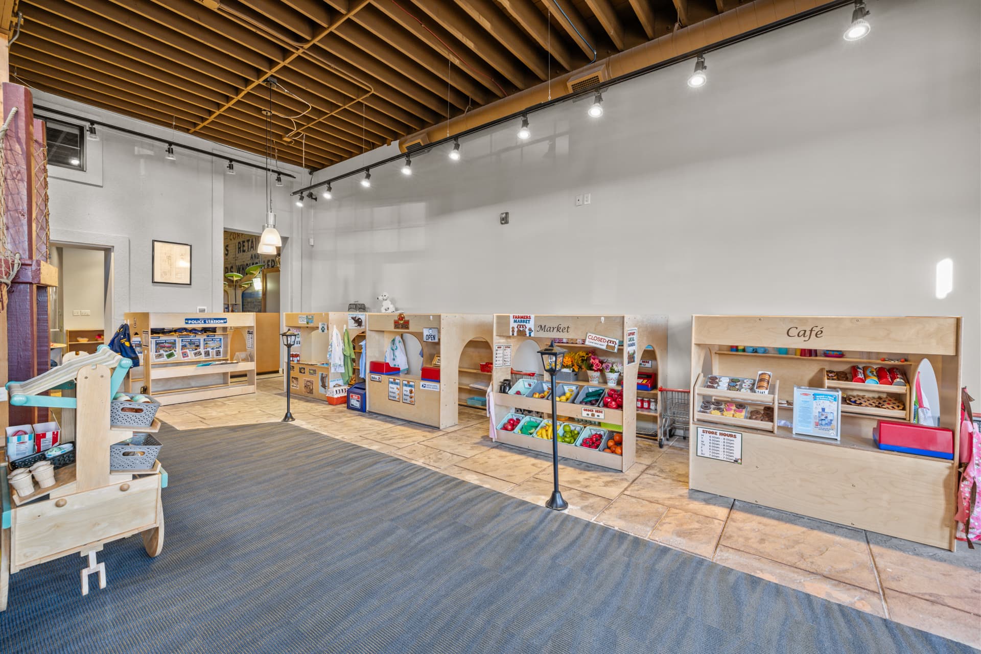 Pretend market and café play stands with play food in the small town at Six Little Ducks