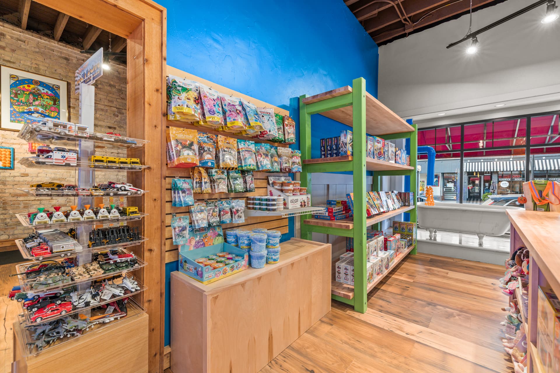Toy cars, sensory play supplies and games beside the shop's front window