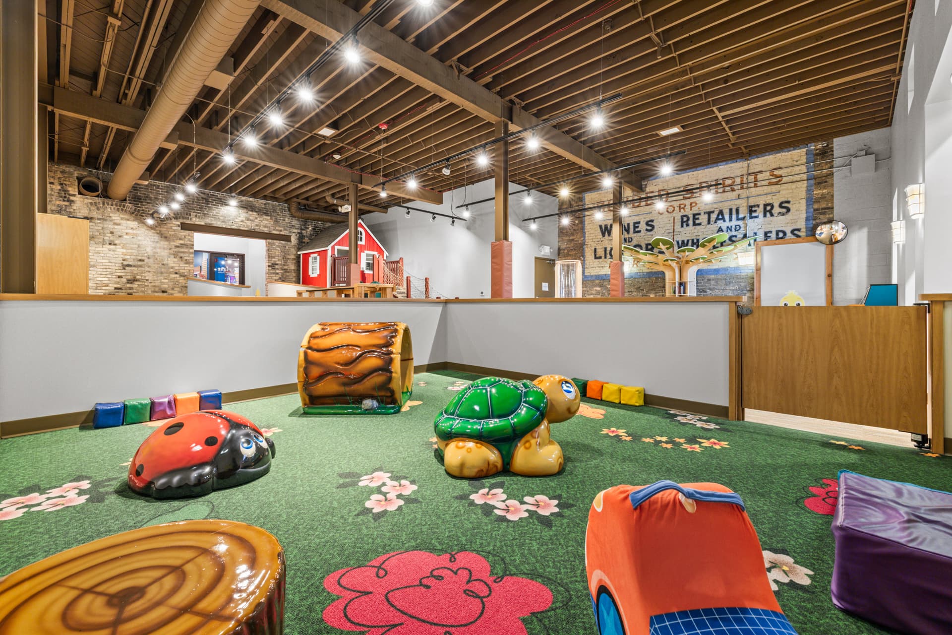 Wide view of the tots area with ladybug, turtle and foam shapes at Six Little Ducks