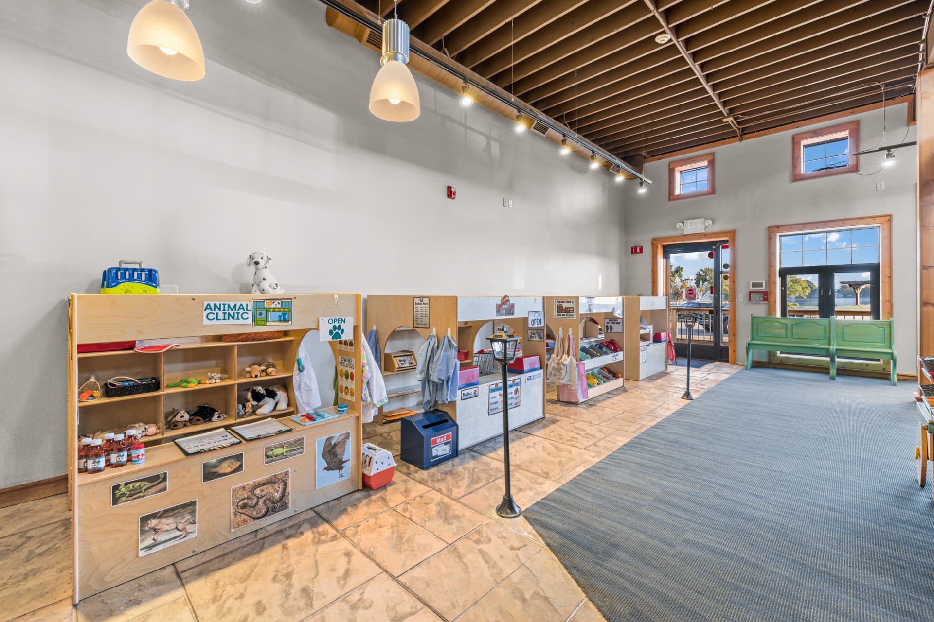 Pretend town with an animal clinic, market stand and play costumes at Six Little Ducks play space