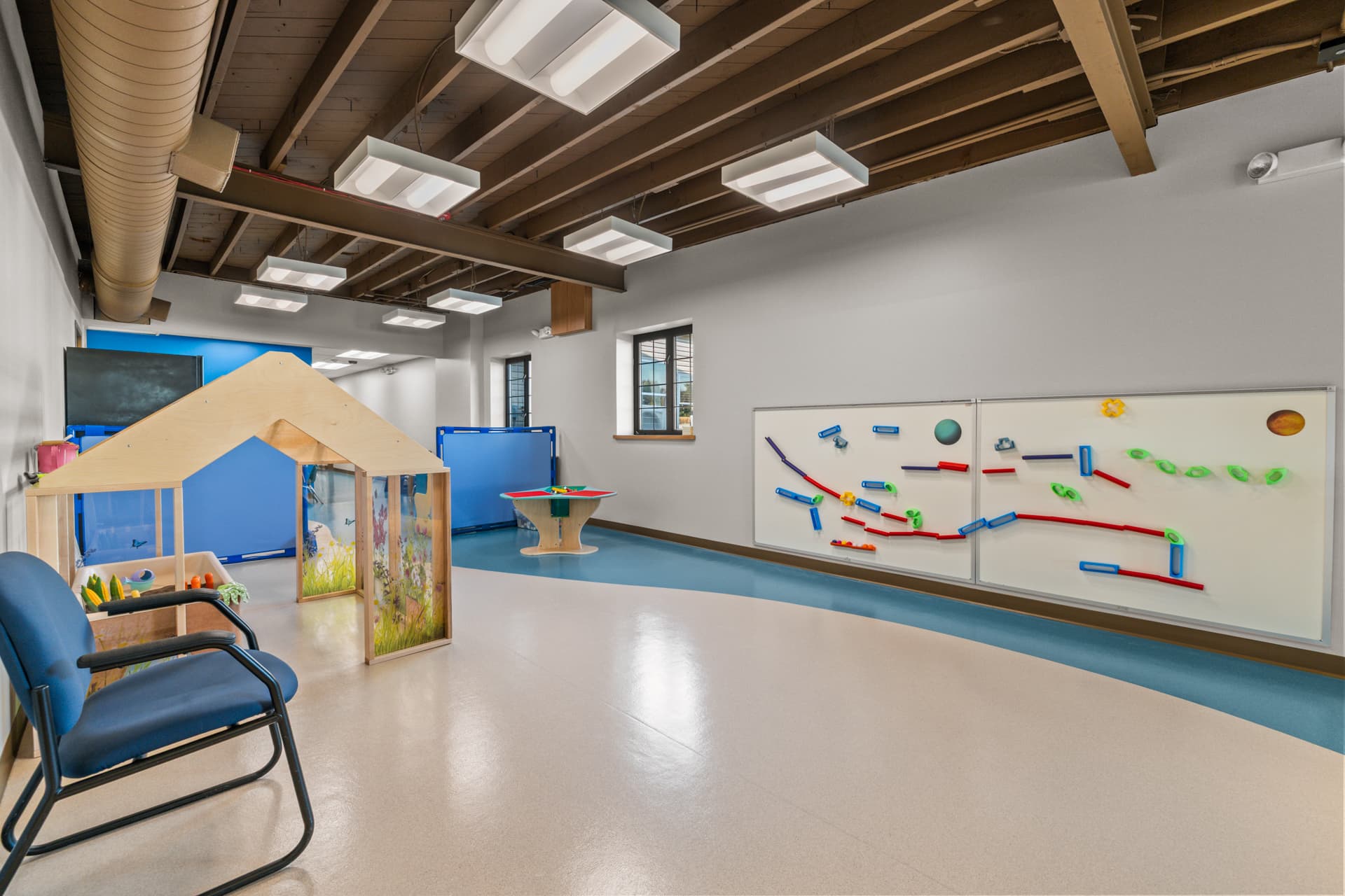 Magnetic ball run wall and garden playhouse in a play room at Six Little Ducks